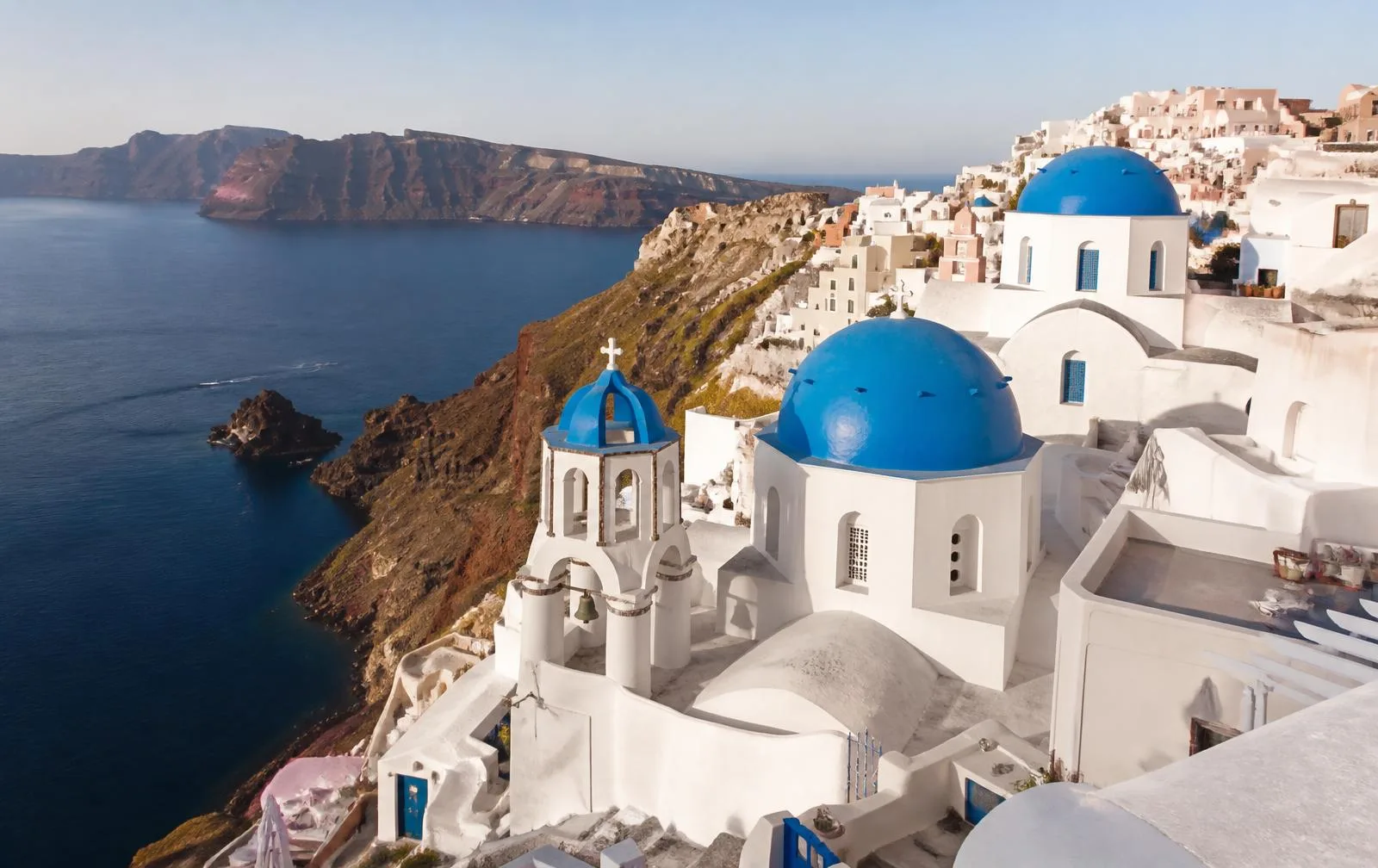 Whitewashed buildings and blue-domed churches overlooking the Aegean Sea in Oia, Santorini